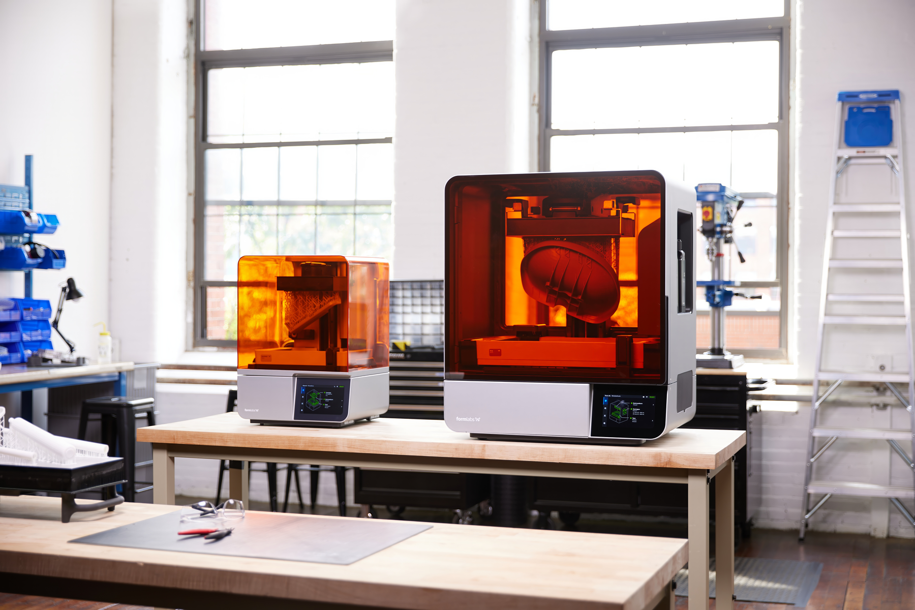 2 3d printers sit in a classroom setting