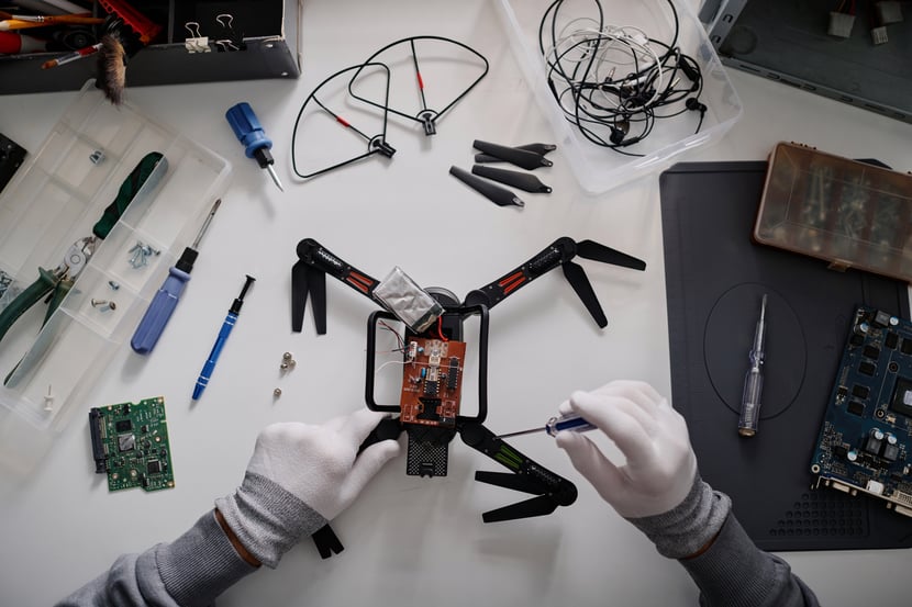 repairman-fixing-drone-by-tightening-its-cogs-with-2026-01-07-23-22-07-utc